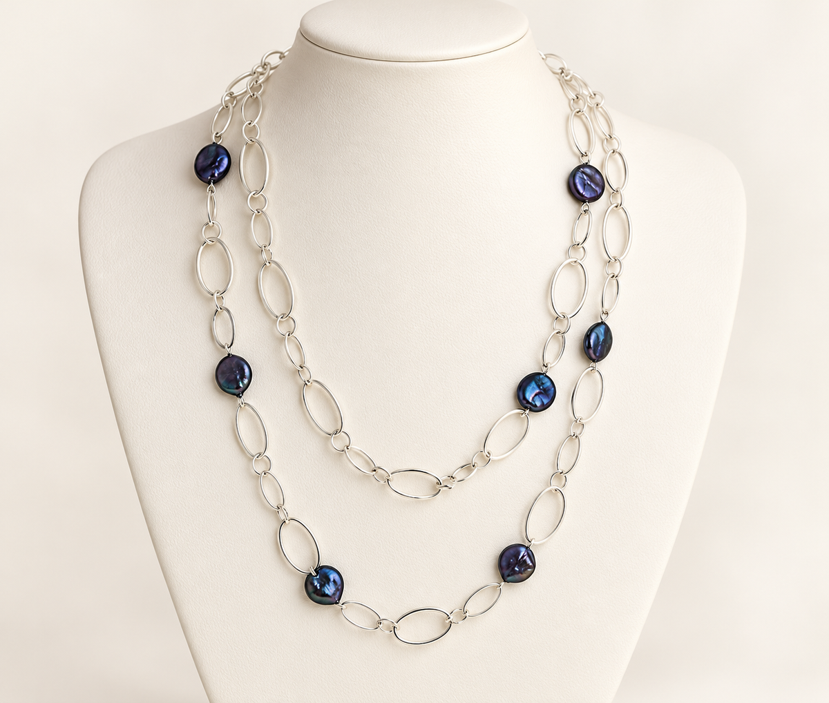 Black coin pearl station necklace with silver-plated chain shown doubled