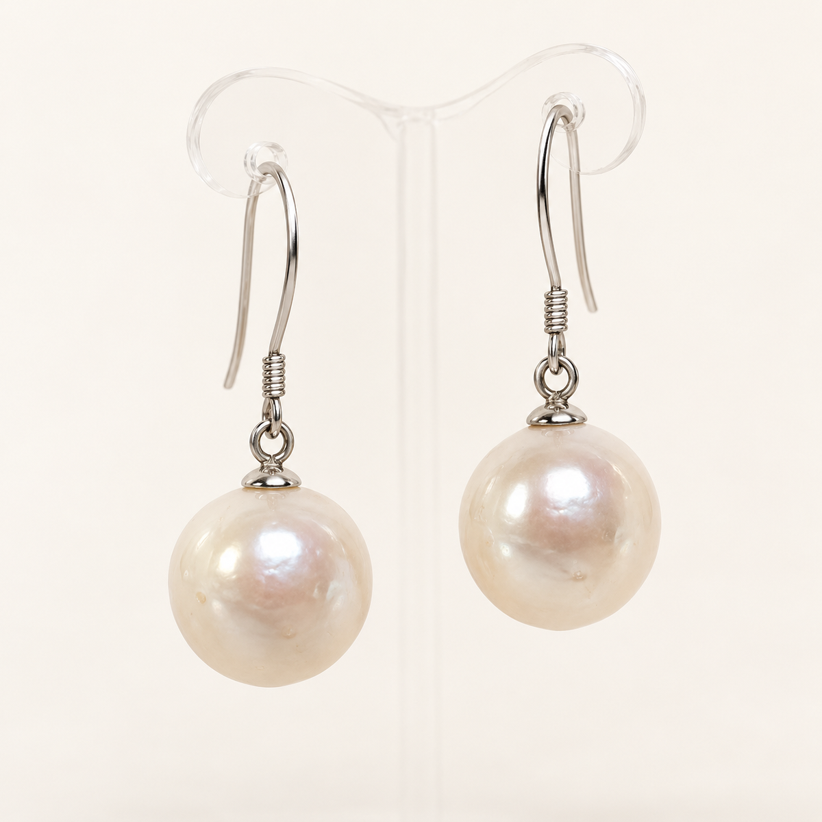 Studio visualization of 12mm white cultured pearl drop earrings with sterling silver French hooks