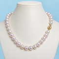 AI product visualization of white pearl necklace with 14K gold lantern clasp