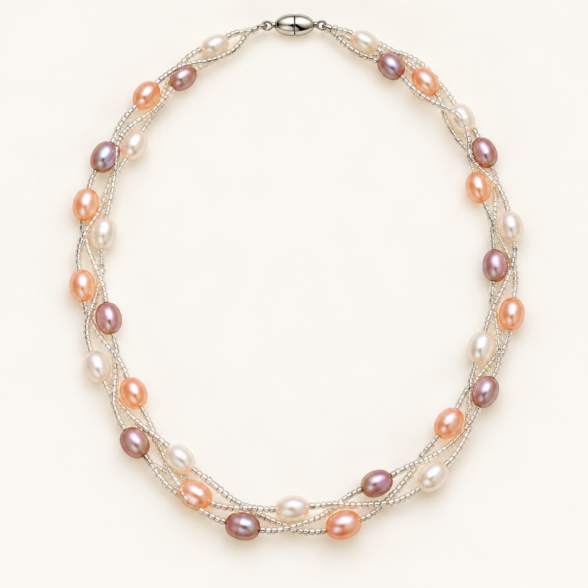 White peach and pink rice pearl twist necklace on ivory background