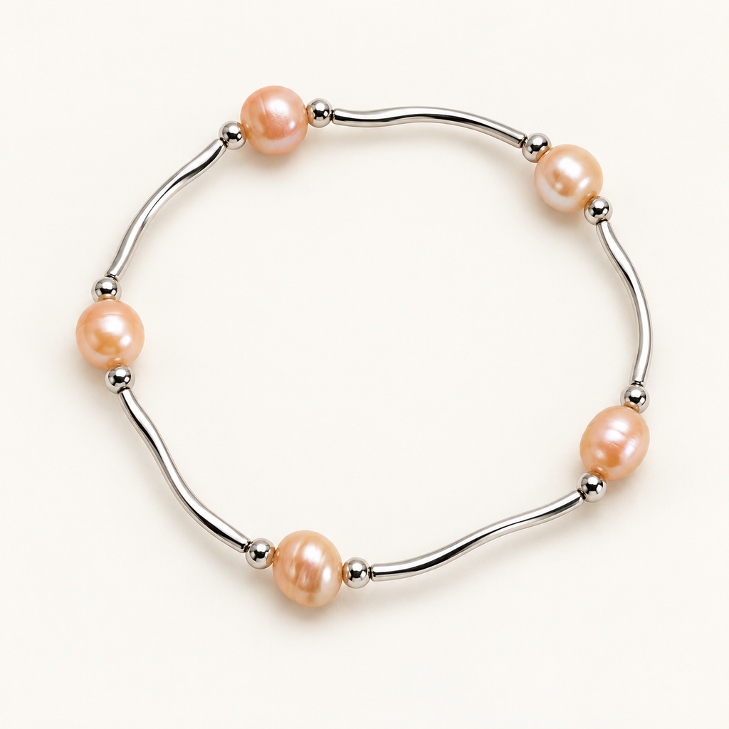 Peach freshwater pearl and silver-tone bar stretch bracelet on ivory background