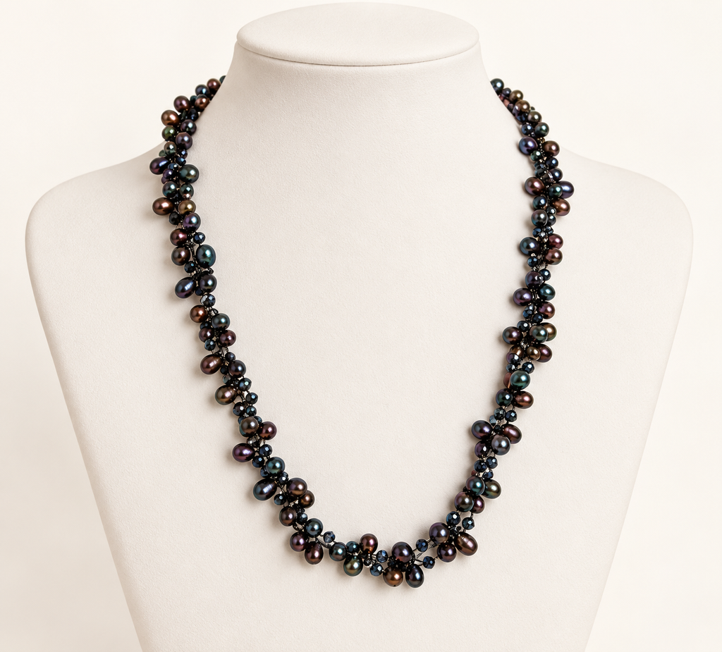 Cultured freshwater peacock pearl and crystal necklace on ivory bust