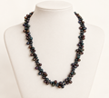 Cultured freshwater peacock pearl and crystal necklace on ivory bust