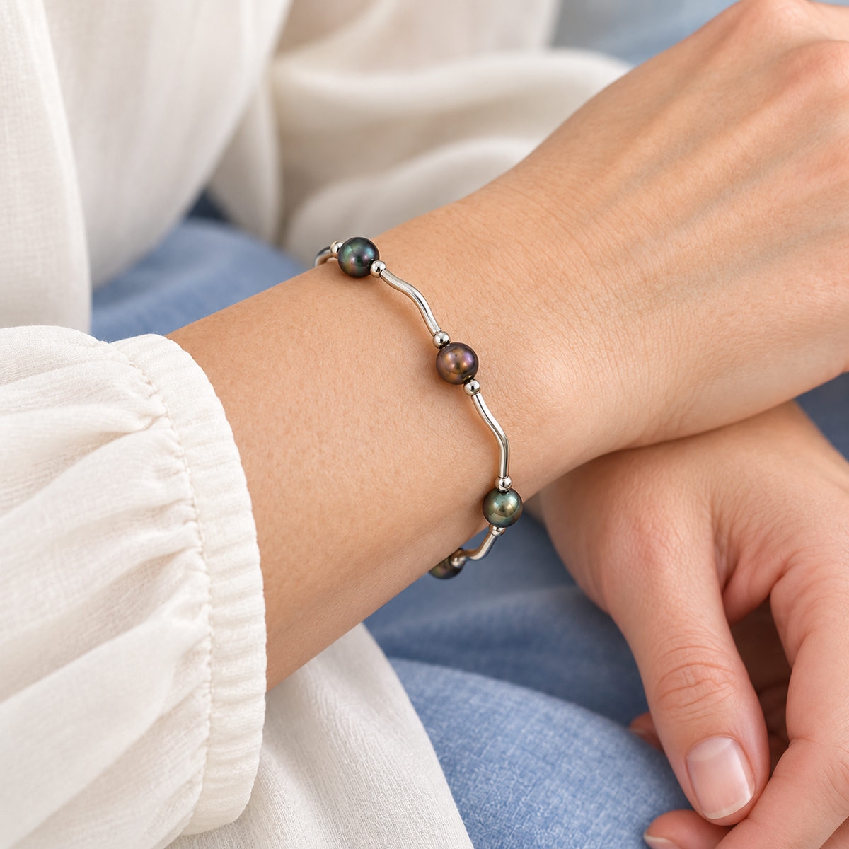 AI styling visualization of a woman wearing peacock freshwater pearl silver-tone bar bracelet