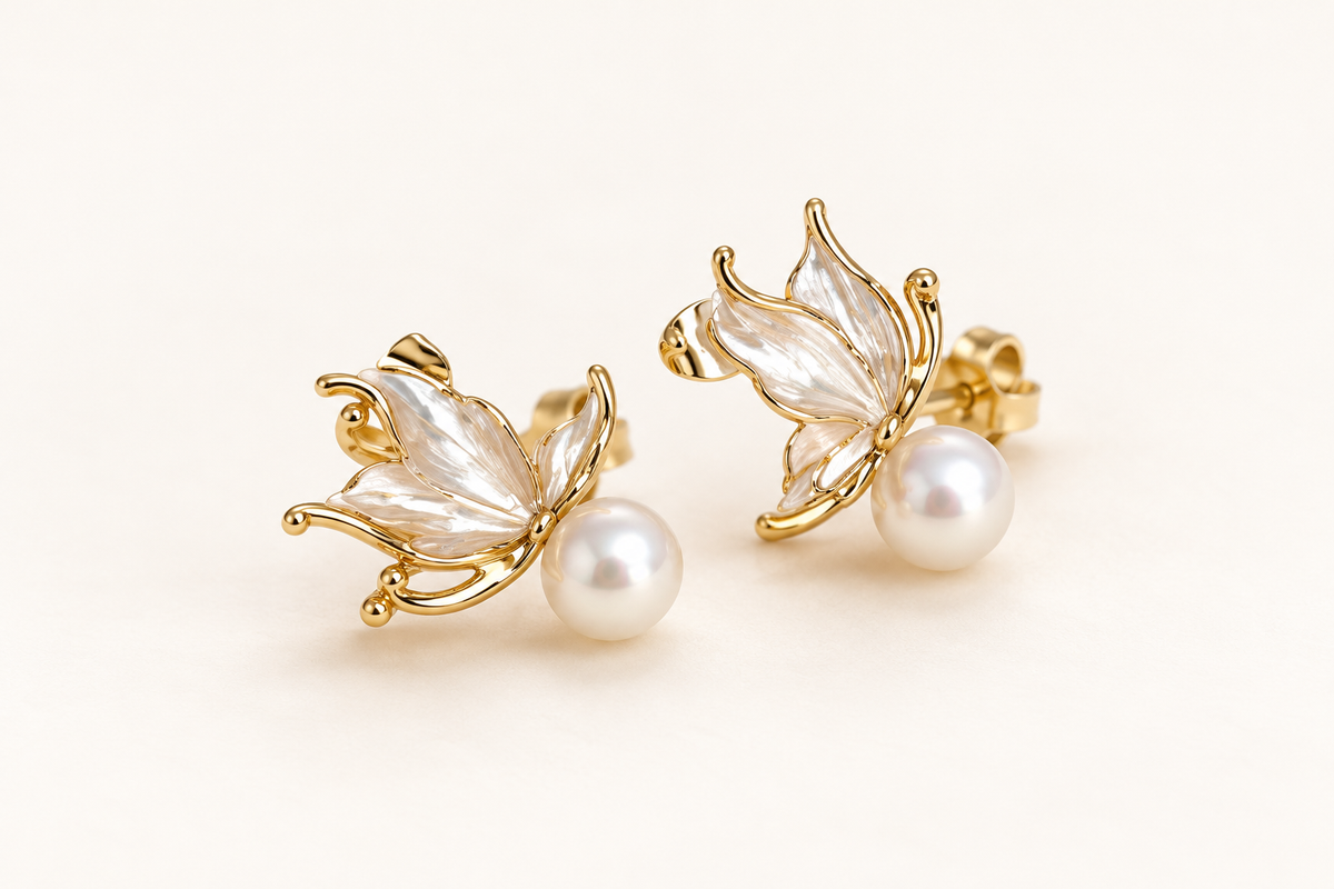 Sea Angel white freshwater pearl stud earrings with gold-tone wing details