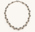 Silver-grey rice pearl twist necklace on ivory background