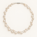 White rice pearl three-strand twist necklace on ivory background